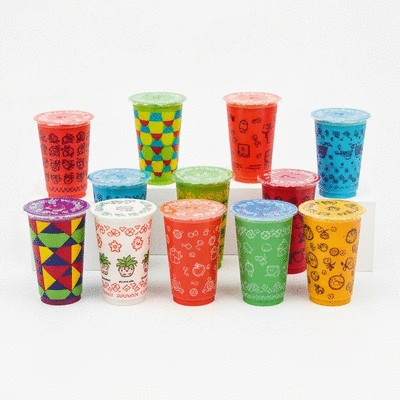 Assortment of colorful plastic juice cups with different designs